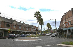 A street with cars and buildings

AI-generated content may be incorrect.